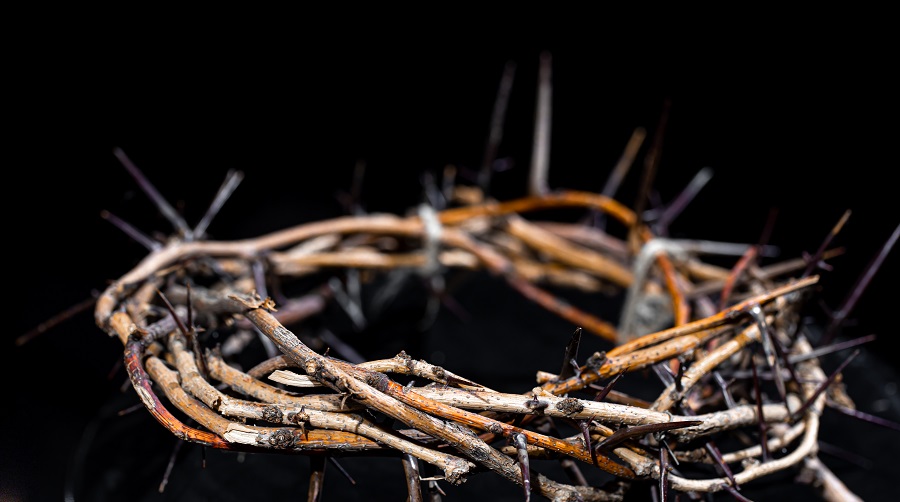 Crown of thorns in the dark close up. The concept of holy week, suffering and crucifixion of Jesus.