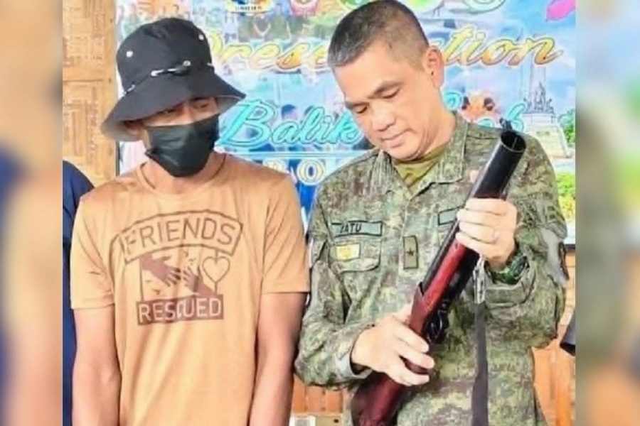 Army Brig. Gen. Edgar Catu reviews a 40‑millimeter grenade launcher relinquished by the leader of eight BIFF members at their surrender on Thursday, July 30, 2026.